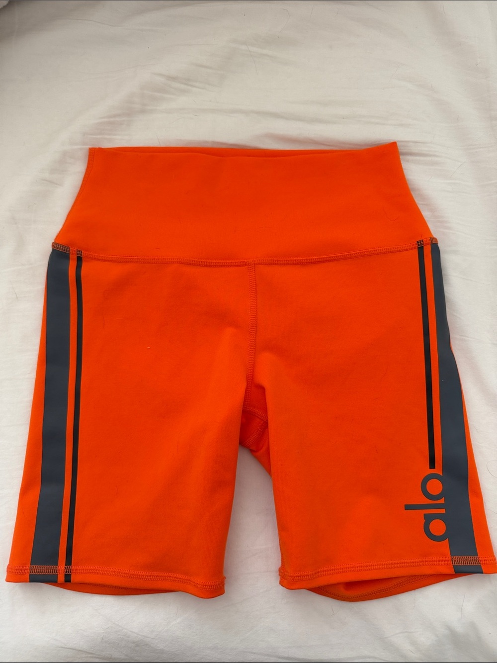 ALO Yoga Orange High-Rise Bike Shorts with Dark Stripe Detail